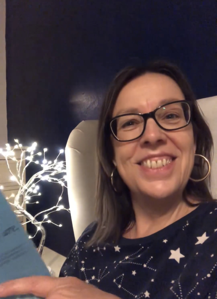 Niki Duffy sitting up in bed reading a bedtime story